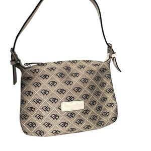 Dooney & Bourke signature monogram canvas & leather bag. Approx 10”L X 2.5”W